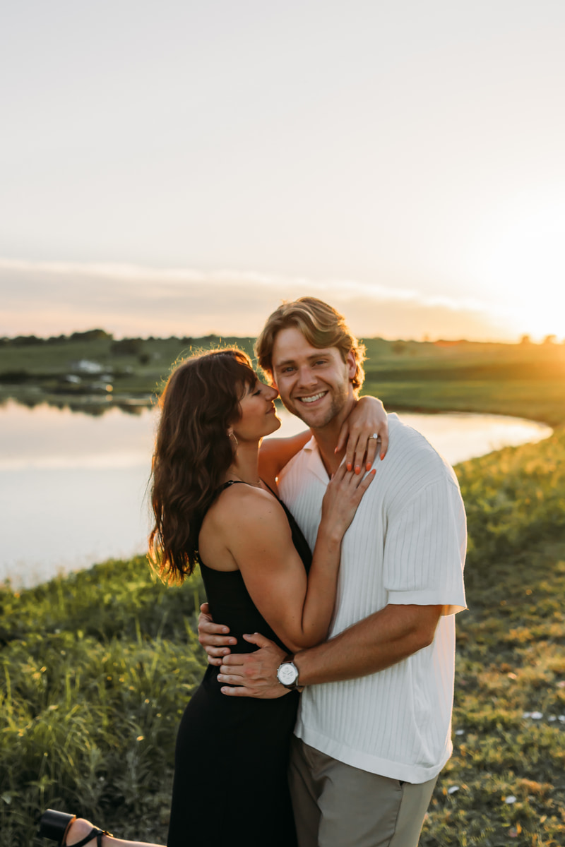 Couple embracing at golden hour by the lake