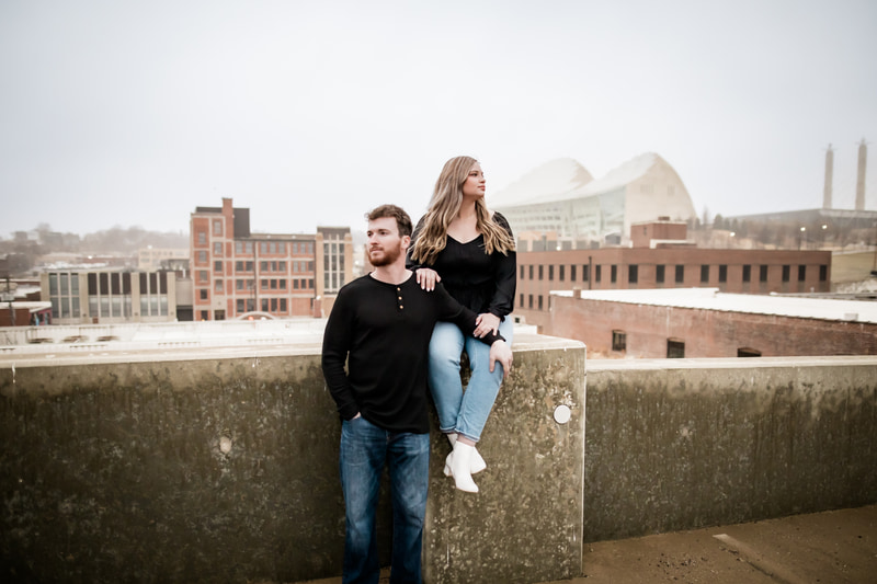 Couple on rooftop overlooking Kansas City skyline