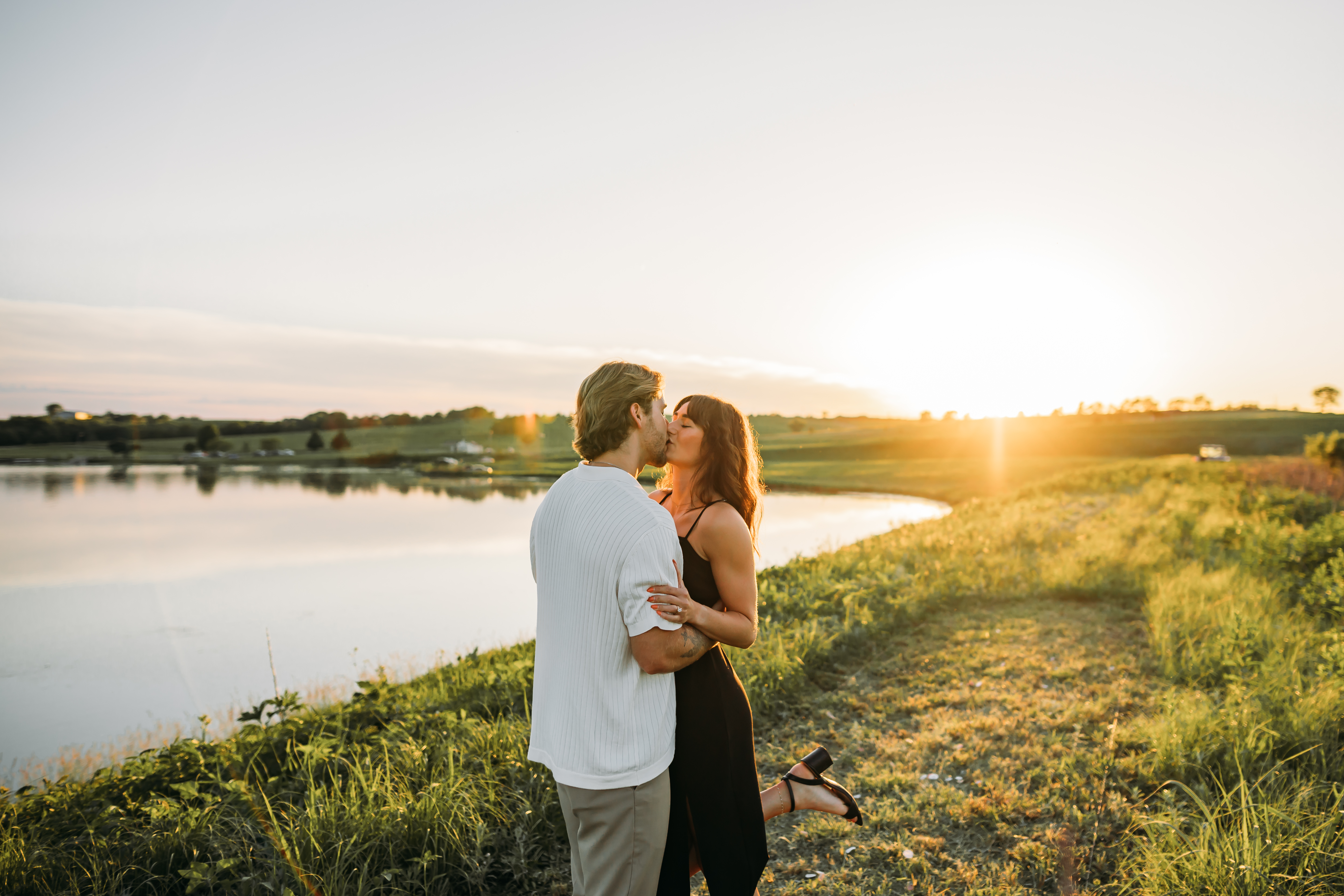 Couple at golden sunset by the lake